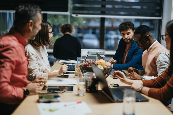 Elite Mutual Fund office with team members collaborating
